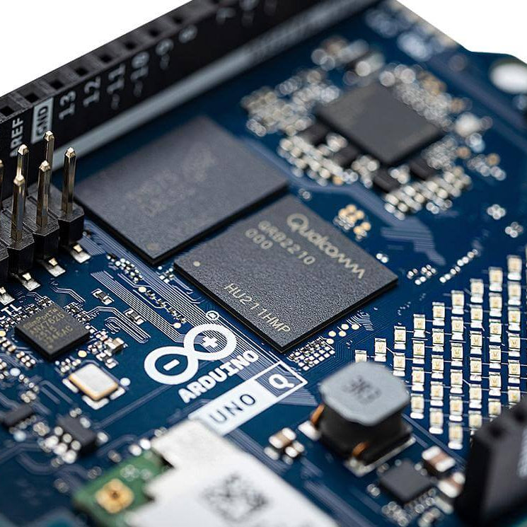 Close-up of a blue circuit board with Qualcomm chips and Aquino branding.